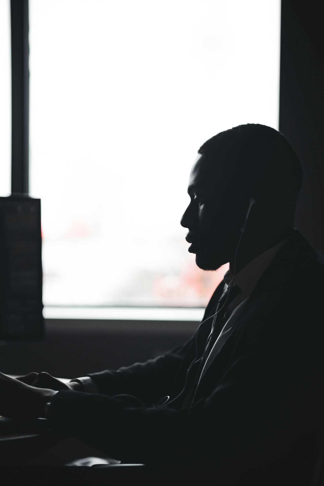 a man sitting in front of a laptop computer